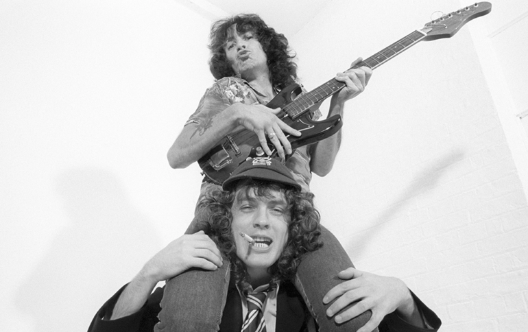 Bon Scott of AC/DC on Angus Young's Shoulders