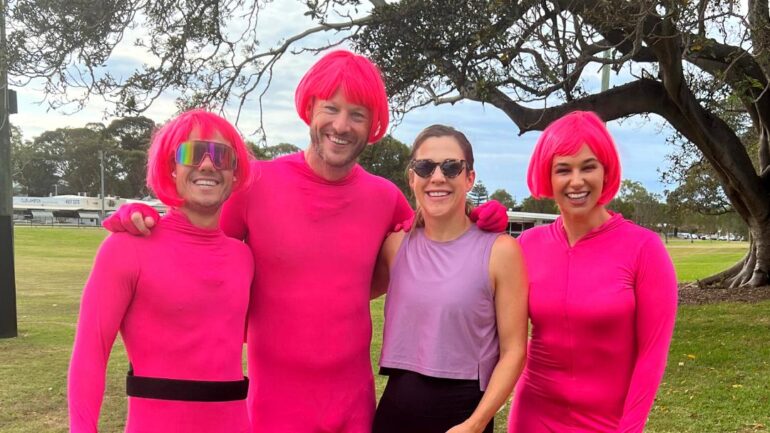 Nick, Jess & Ducko in pink morph suits posing with a listener.