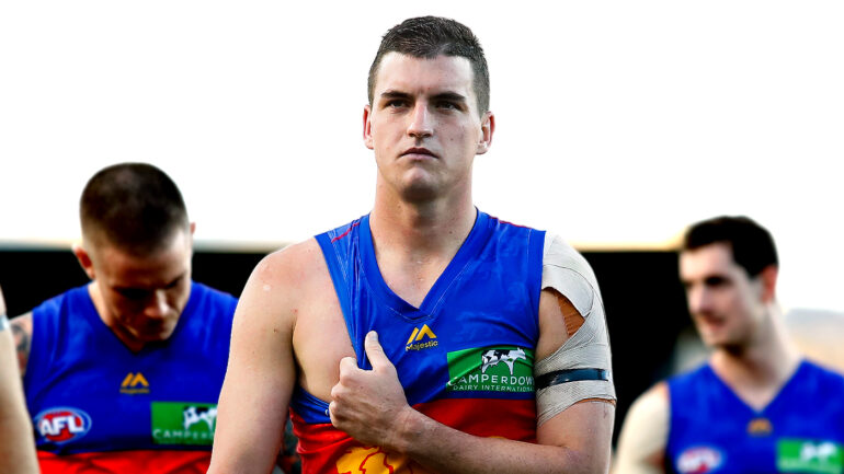 A dejected Tom Rockliff leads Brisbane off the ground