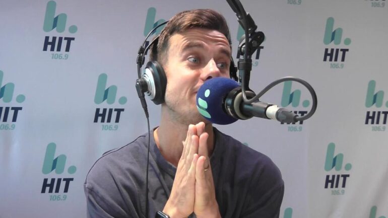 Ducko in radio studio with hands in praying position.