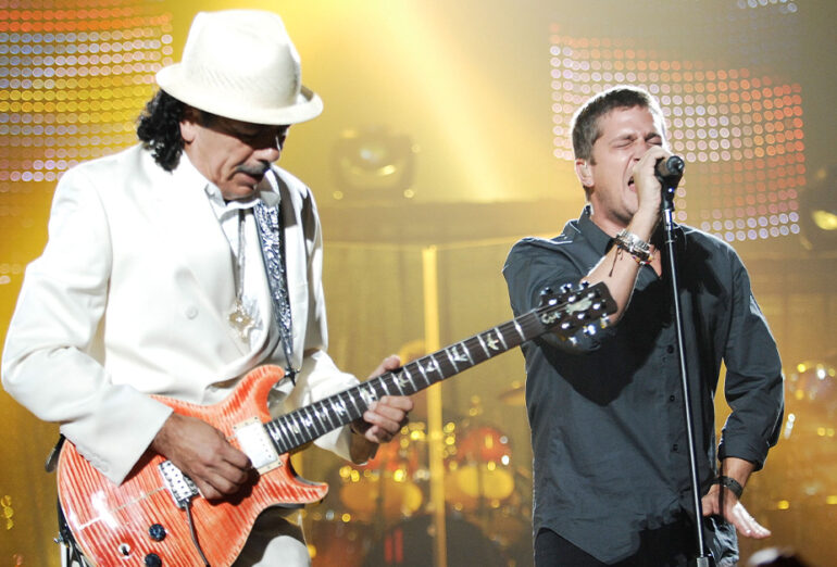 Carlos Santana and Rob Thomas on stage.