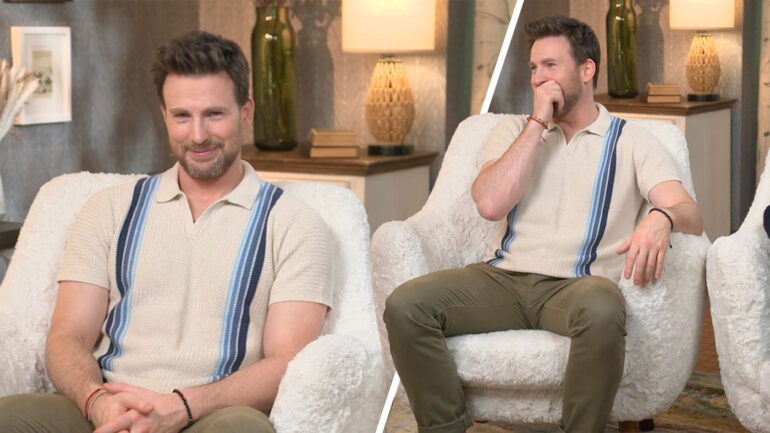 chris evans sits on a couch smiling