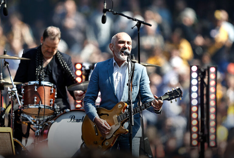 Paul kelly pictured on stage at the 2019 AFL grand final.