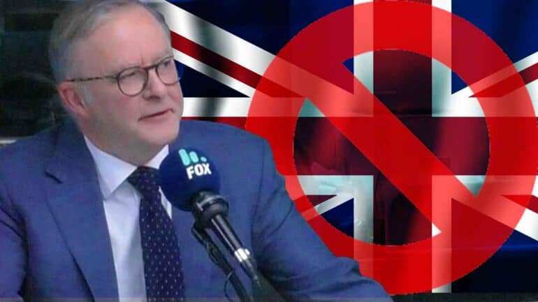 Anthony Albanese in 101.9 The Fox studio with a Union Jack crossed out in background