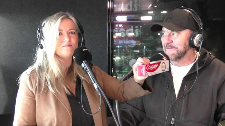 Tanya holding a packet of toothpaste and Steve looking.