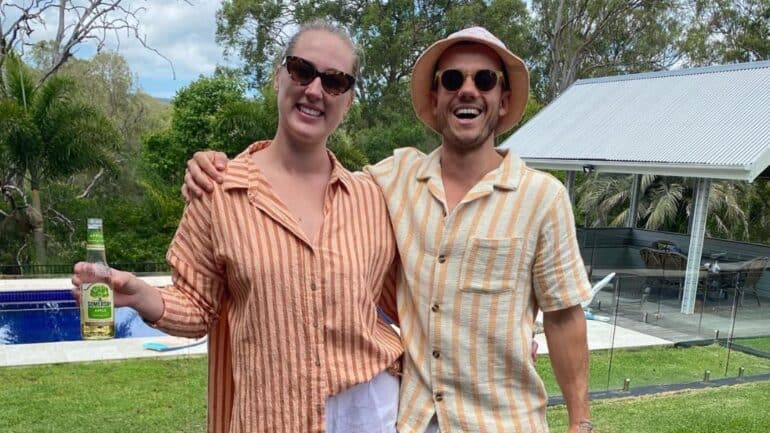 Ducko and Morgan smiling in button up shirts and sunnies.