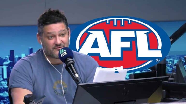 Brendan Fevola in studio, AFL logo in background