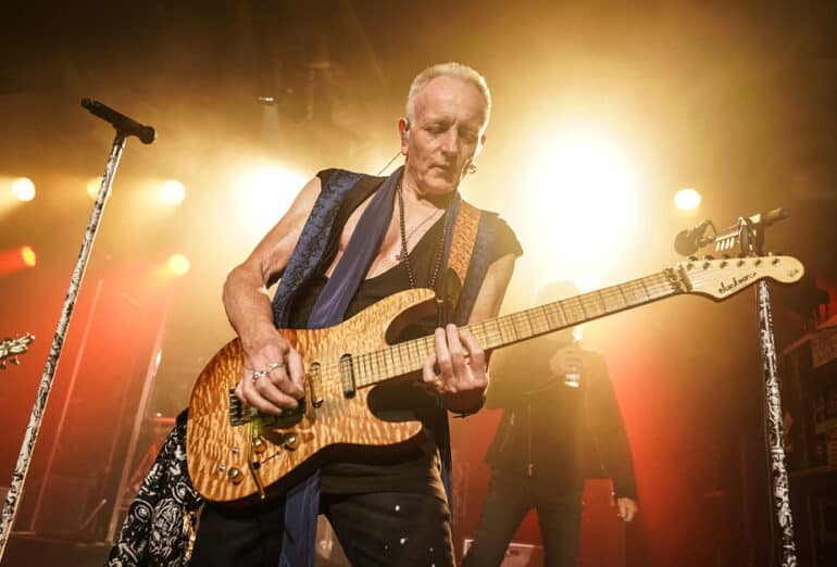 Phil Collen performs on stage with Def Leppard during their 