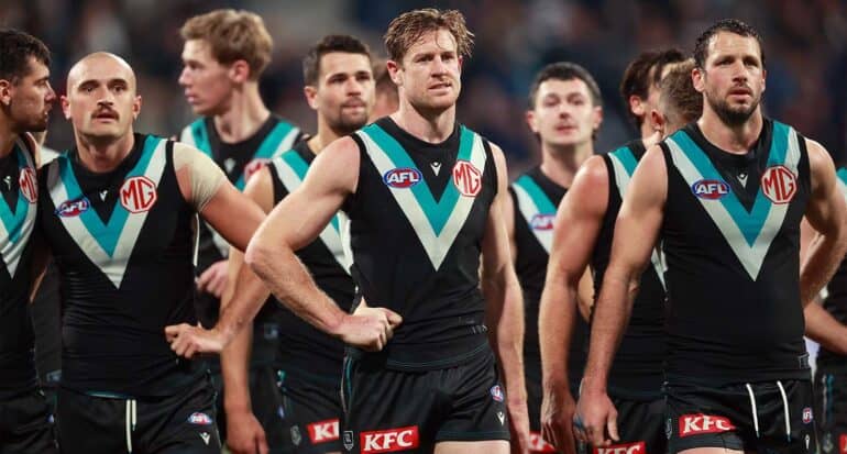 Tom Jonas of Port Adelaide stands with team