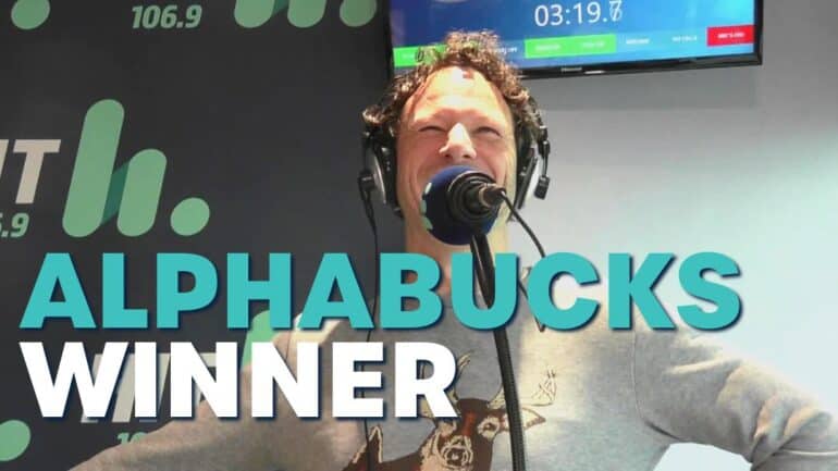 Nick smiling with text saying 'Alphabucks Winner'.