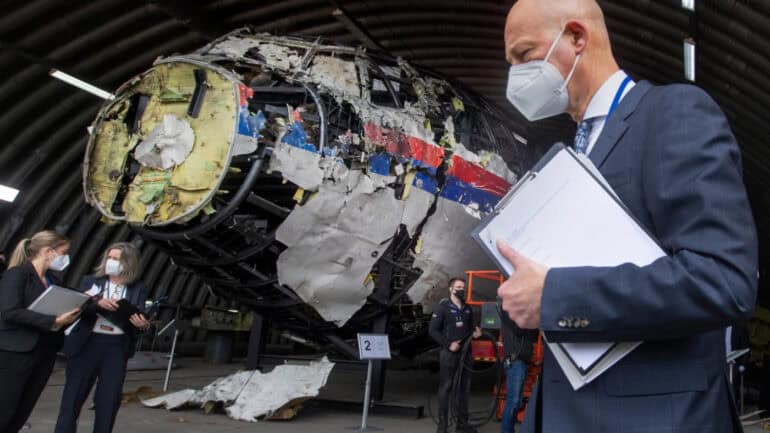 Trial judges and lawyers view the reconstructed wreckage of Malaysia Airlines Flight MH17.