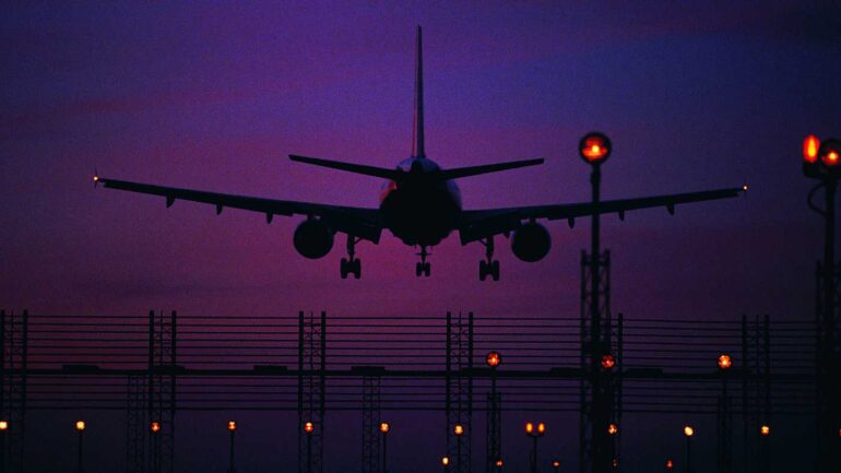 Silhouette of a plane landing